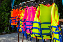 Many Colorful Life Jacket Or Life Vest Hanging On A Clothesline