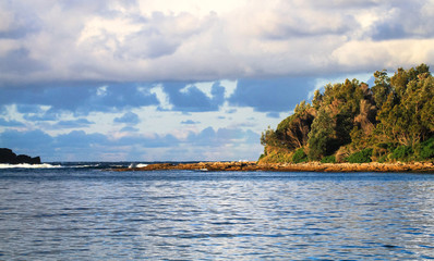 Wall Mural - A natural rock jetty sticks out into the ocean at Jervis Bay National Park, New South Wales, Australia.