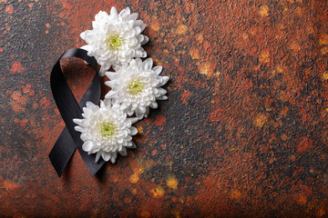 Wall Mural - Black mourning ribbon and flowers on grunge background