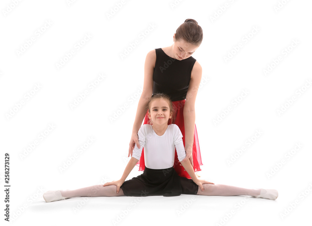 Little ballerina training with coach against white background