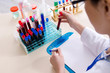 © Elnur - Young female chemist working in the lab