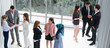 © InfiniteFlow - Many business people gathering in modern office building for business conference in the city. Businessmen and businesswomen communication and human resources concept.