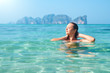 Happy young woman enjoying swimming in refreshing sea water Phi Phi Island, Thailand