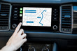 Touching a monitor with navigation map of the modern car, close-up view
