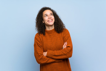 Wall Mural - Dominican woman with curly hair looking up while smiling