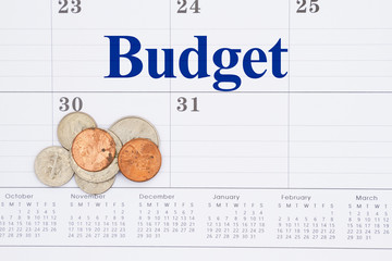 Wall Mural - Budget your money message on a monthly calendar with coins