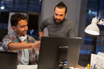 deadline, technology and people - creative team coworkers with computers working together late at night office