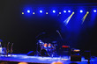© Vulp - Empty illuminated stage with drumkit, guitar and microphones