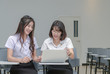 © kwanchaichaiudom - Students in uniform working with laptop