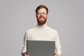 cheerful programmer with laptop