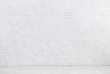 © Prostock-studio - White brick wall and white wooden floor