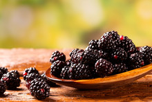 Fresh Blackberries In Wood Bowl On Wooden Table. Selective Focus.