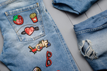 sewing beautiful patches to jeans