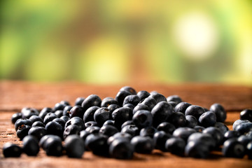 Wall Mural - Blueberry on wooden table background. Berries closeup