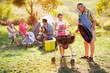 © luckybusiness - grandfather and granddaughter making barbeque .