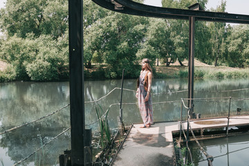 woman standing on the bridge on a summer day