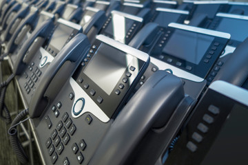 lines of office IP business phones grey and silver phones ready for business telecommunication