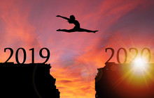 Sunrise Silhouette Of Girl Leaping Over Cliff Toward New Year 2020