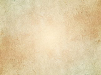 Wall Mural - An elegant, beige, tan, grunge parchment texture background with glowing center. 