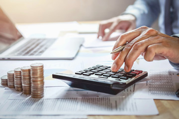 Poster - businessman working on desk with using calculator for calculate finance and accounting in office