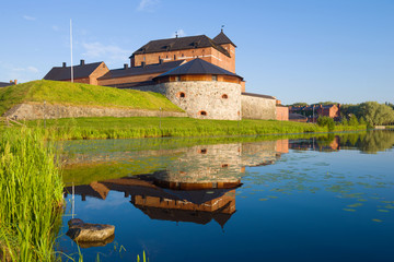 The old fortress-prison of Hame on the shore of Vanajavesi  lake on a sunny July morning. Hameenlinna, Finland