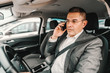 © Dusan Petkovic - Irresponsible middle aged man driving car and using smart phone for call.