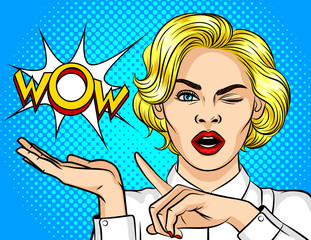 Wall Mural - Color vector illustration pop art girl winks and point the finger to the side. Wow effect. The girl is surprised. Shocked girl points to the bubble with the word wow. Promotional poster for discounts