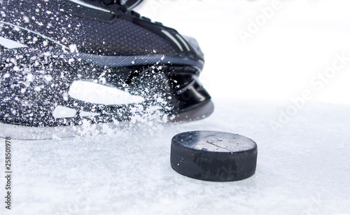 hockey skate with snow splashes and puck Wallpaper Mural