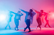 © alfa27 - Young modern dancing group of six adult young people practice dancing on colorful background. Fashionably dressed youngsters moving over blurred disco club color lights