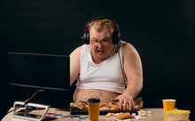Funny Man Is Crazy About Computer Games And Fast Food. Close Up Photo, Isolated Black Background. Studio Shot.