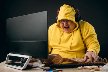 excited funny plump man in trendy clothes surfing the net. close up portrait, isolated black background.