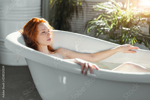 Young Woman With Gorgeous Red Hair Getting Spa Treatment At Beauty