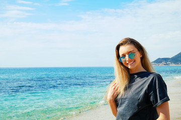 Portrait of young beautiful woman in tropical destination island beach with the ocean background. Joy of summer holidays concept. Close up, copy space