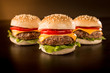 © juanponce - Three mini burgers in a dark ambient