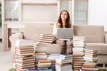 Young female student preparing for exams at home 