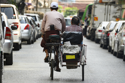 Cuadros en Lienzo A unidentified Sai Kaa driver is carrying a passenger on his side car among the narrow streets of Yangon, Myanmar