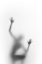 Woman Squatter, And Climb. Human Body Silhouette Can Be Seen Blurred Behind A Diffuse Surface, Only Hands, Palms And Fingers Are Sharp. 