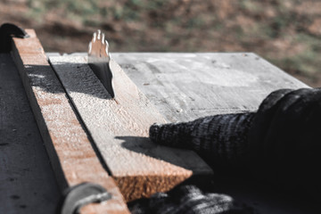 Wall Mural - saw blade. car saws wood. there is a blackboard in the background. working hand