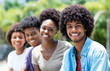 Handsome african american man with group of young adults in line