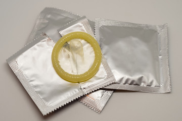 Yellow open condoms on a white background