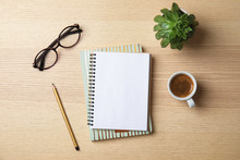 Flat Lay Composition With Notebooks, Coffee And Glasses On Wooden Background