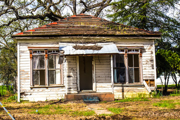 front of uninhabitable abandoned home