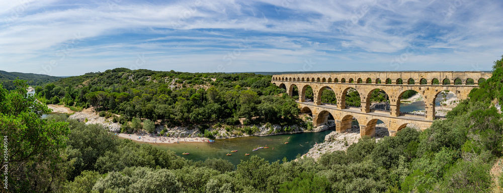 Panoramic view of the magnificent three tiered Pont Du Gard aqueduct was constructed by Roman engineers in the 1st century AD in the south of France - obrazy, fototapety, plakaty 