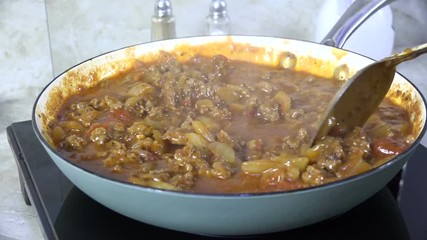 Sticker - Cooking marinara sauce with beef closeup