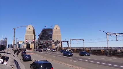 Poster - Car traffic on Cahill Express way leading to the Sydney Harbour Bridge sandstone gates on a sunny summer day.