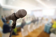 © nattanan - Microphone over the blurred business forum Meeting or Conference Training Learning Coaching Room Concept, Blurred background.