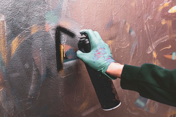 Wall Mural - artist hand drawing graffiti  with the aerosole spray paint on the wall can