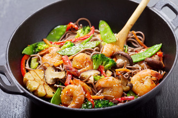 Sticker - Stir fried noodles with shrimps and vegetables in a wok