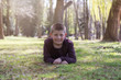 © Vince Scherer  - Smiling young boy lying on grass in the park