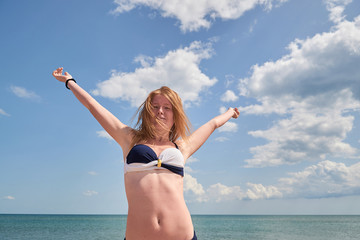 Portrait of handsome woman on sea background. Concept of holiday